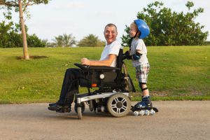 Disabled father rollerblading with son